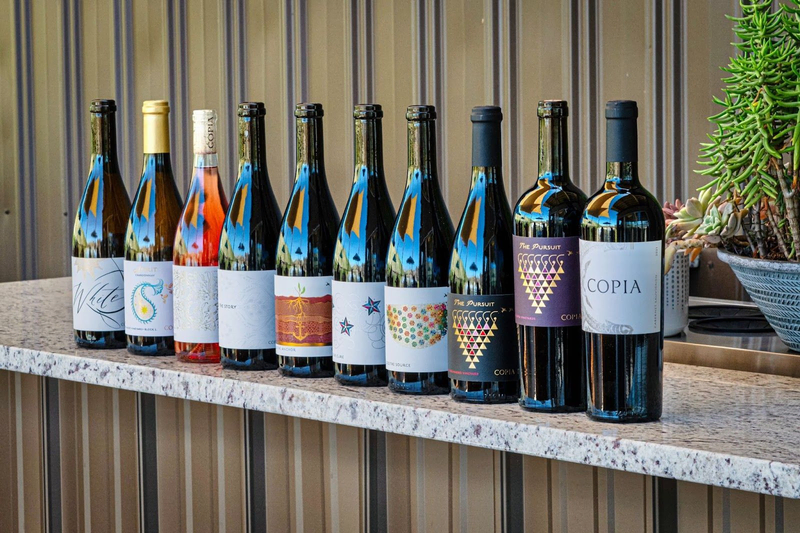 Copia Vineyards wine bottles displayed on granite counter