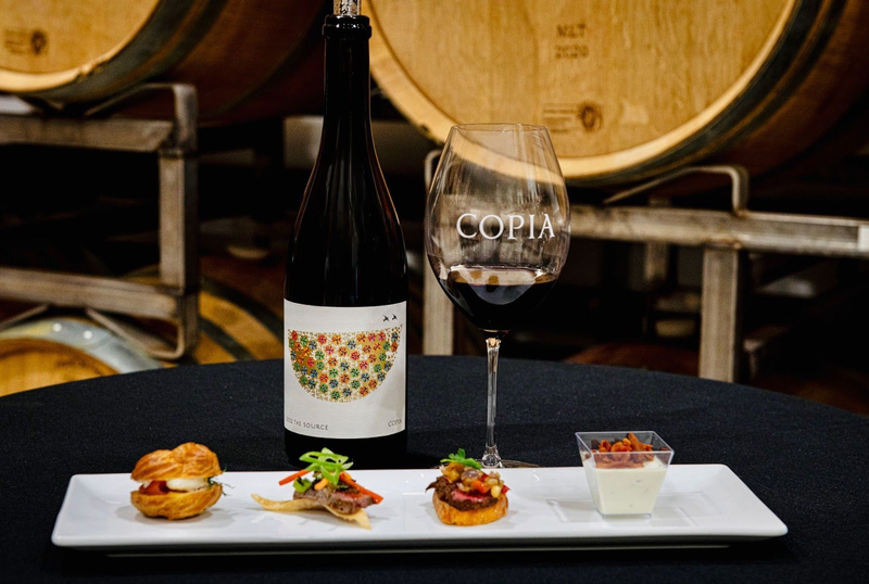 Copia wine bottle and glass with gourmet food pairing