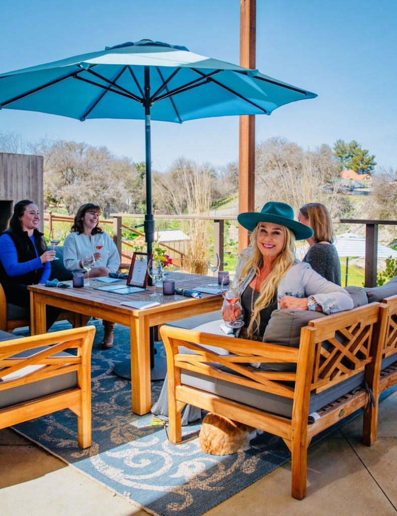 Guests enjoying wine on Copia Vineyards patio terrace