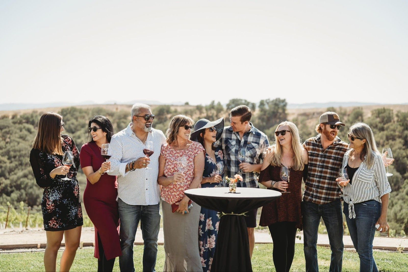 Group enjoying wine at Copia Vineyards outdoor tasting