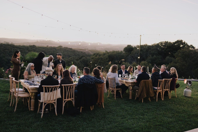 Outdoor dinner gathering at Copia Vineyards with scenic views