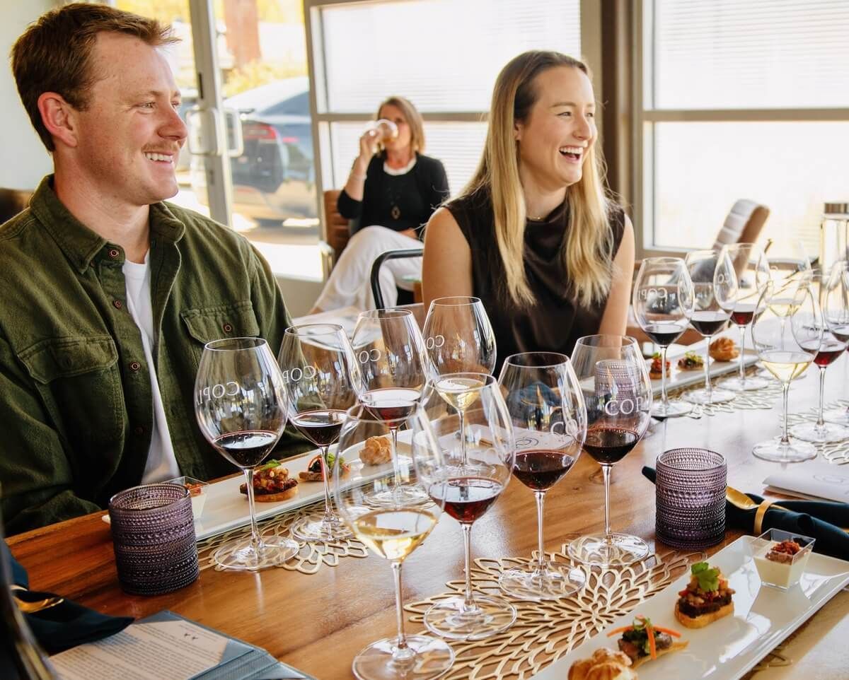 Guests enjoying wine tasting at Copia Vineyards