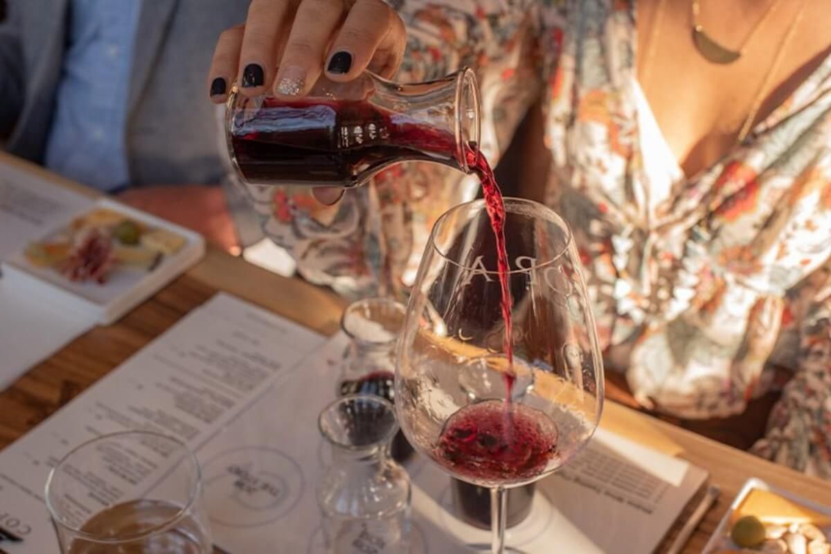 Pouring red wine at Copia Vineyards tasting room