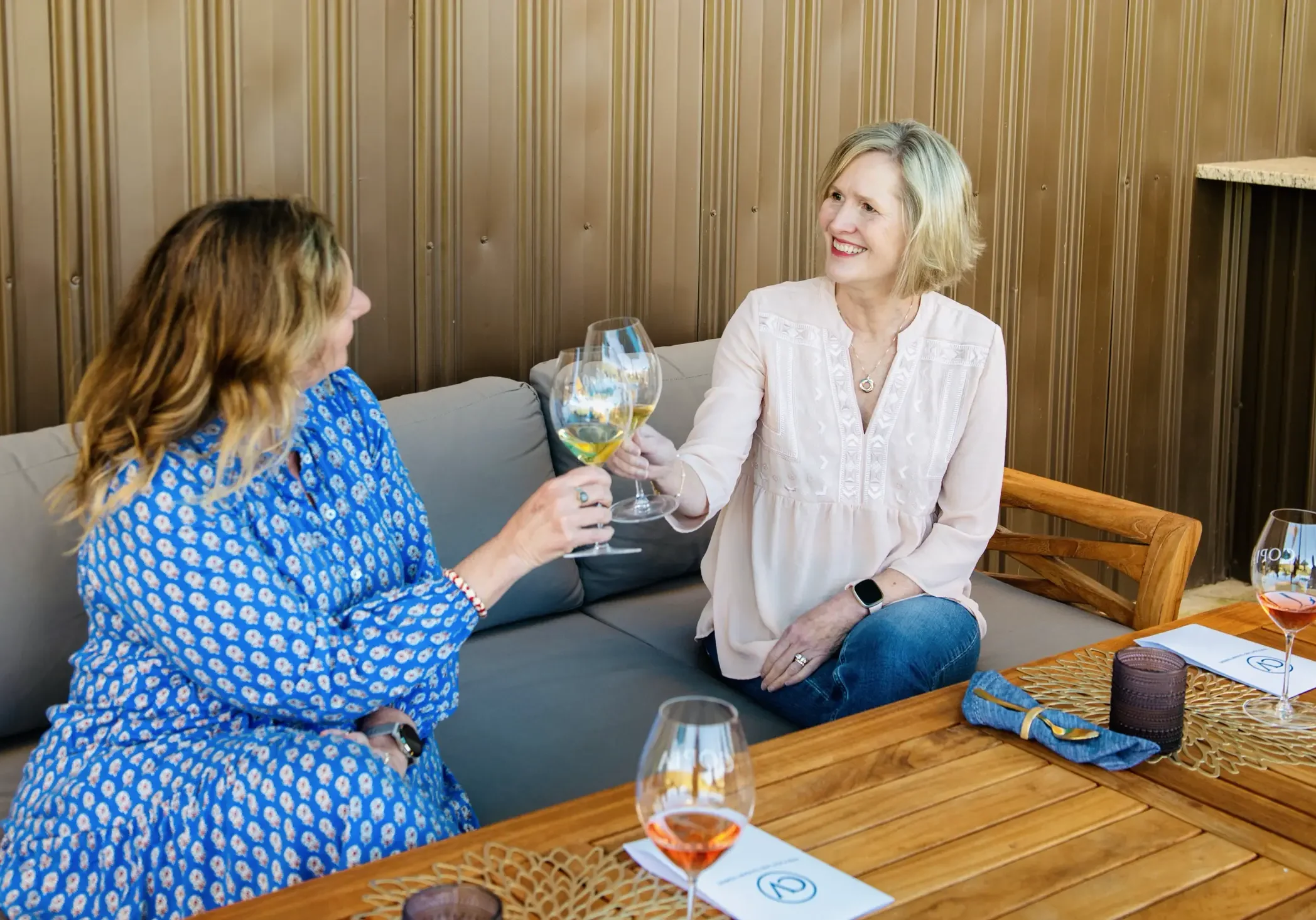women toasting on the couch